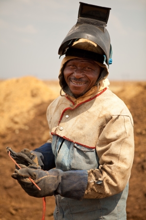 Oil and gas pipeline welder worker with safetly mask, gloves and equipmentの写真素材