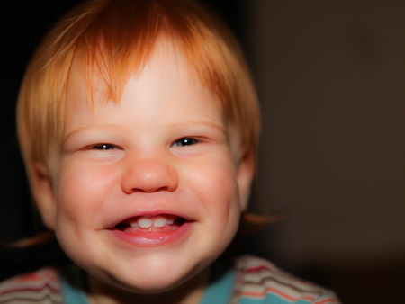 Redhead boy with cheeky smile and dimplesの写真素材