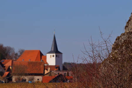 church in a village behind a rock