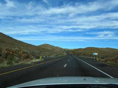 the way forward on a highway through the mountains in arizona