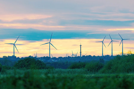 Wind turbines on the field at sunset. Alternative energy source. Selective focus.