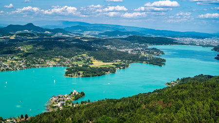 View of the shoreline landscape and churches of Maria WÃ¶rth on Lake Woerthersee in Austria.
