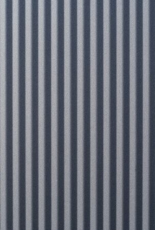 gray textured aluminum sheet closeup / macro in the sunlightの写真素材