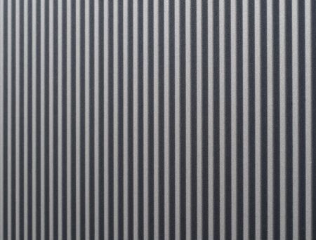 gray textured aluminum sheet closeup / macro in the sunlight