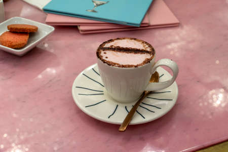 Italian espresso coffee with chocolate milk and biscuits
