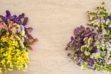 Background made with natural light wood and a composition of statice flowersの写真素材