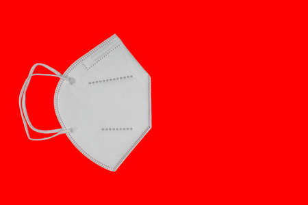 Mask type FFP2 isolated on red backgroundの写真素材