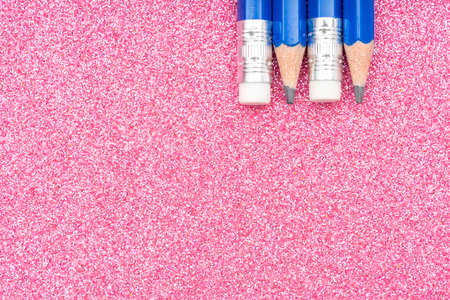 Pink school background with blue pencilsの写真素材
