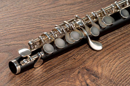Close up of a Piccolo Flute on a brown wooden background