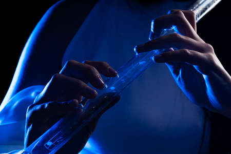 Close up of the hands of a young woman playing a crystal fluteの写真素材