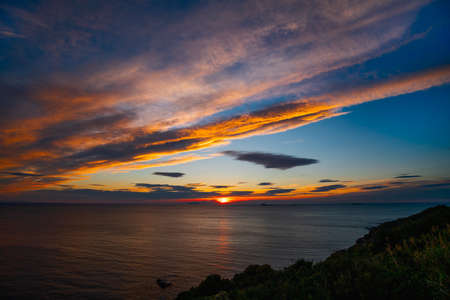 A fantastic sunset in an ocean bayの写真素材