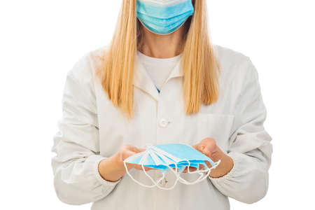 A nurse holding some surgical masks isolated on white background