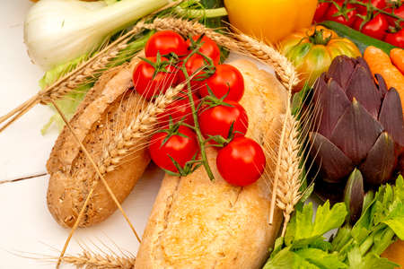 Red cherry tomatoes on top of wholemeal breadの写真素材