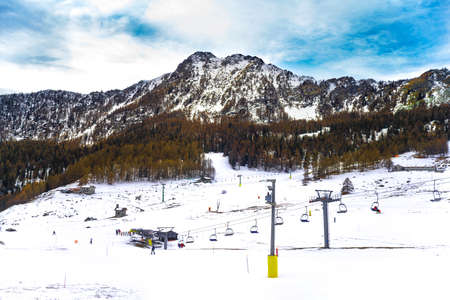 Snow-capped mountains with ski lifts
