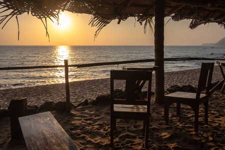 An empty wooden bar on the beach at sunsetの写真素材