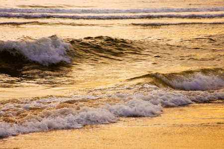 Golden sunrise reflecting on waves, Plettenberg Bay, Garden Route, South Africaの写真素材