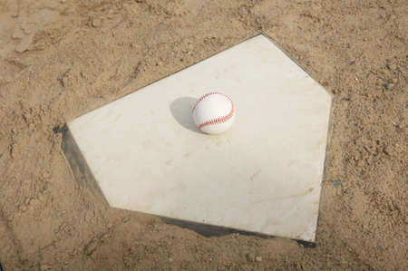 Baseball on home plate of ballpark fieldの写真素材
