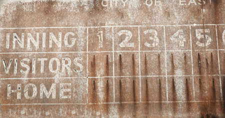 Old faded baseball scoreboard vintage rusty backgroundの写真素材