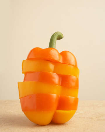 Still life of slices of yellow and orange peppersの写真素材