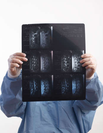 Doctor in surgeon gown looking at mri x-rayの写真素材