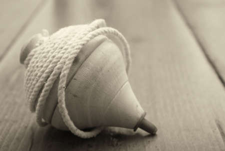 Classic wooden top toy with string sepia toneの写真素材