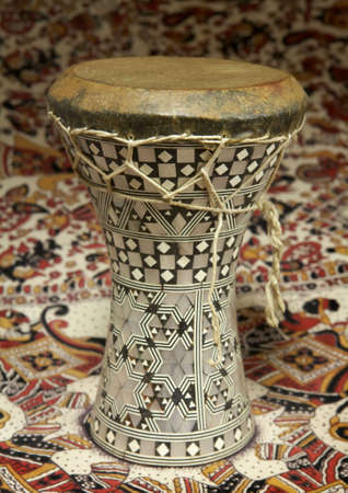 Egyptian silver inlaid dumbek drum on pattern backgroundの写真素材