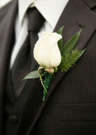 White rose wedding boutonniere on suit of best man
