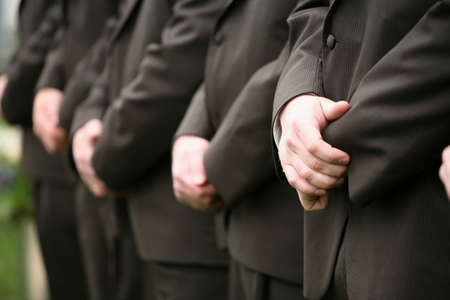 Row of groomsmen's hands at wedding receptionの写真素材