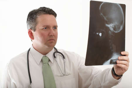 Doctor studying x-ray of human skull and neckbone