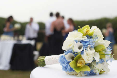 Bridal bouquet with wedding party in background focus on flowersの写真素材