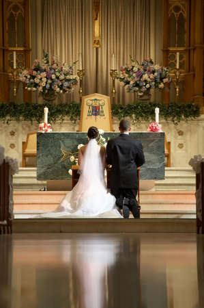 Bride and groom at church wedding alter ceremonyのeditorial素材