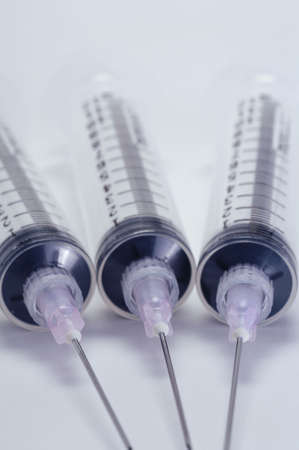 Closeup of three medical syringe needle, subtle cross-processed color の写真素材