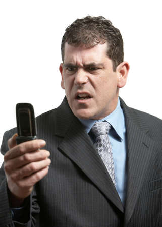 Businessman with bad news on his cell phoneの写真素材