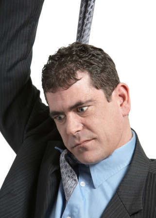 Businessman hanging from tie on white backgroundの写真素材