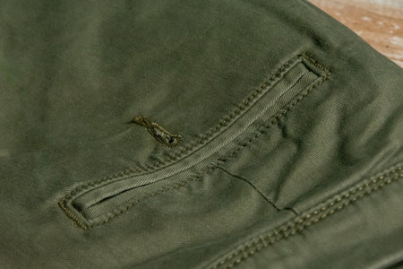 Close up view of back pocket of men's green pantsの写真素材