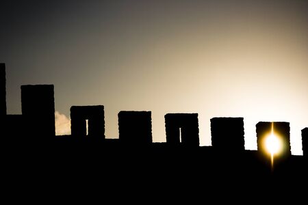 Castle wall with the sun through one of the nichesの写真素材