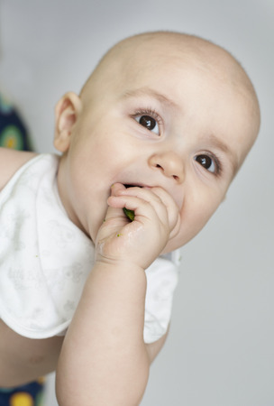 Baby boy eating vegetablesの写真素材