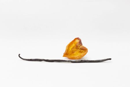 valentines heart with a sweet orange peach and vanilla pod on a white backgroundの写真素材