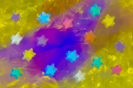 colored abstract bright stars on a gold and purple background 