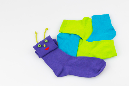 colored socks in the form of a snail on a white background の写真素材