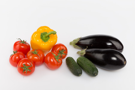 cucumbers and tomatoes peppers eggplant on a white background の写真素材