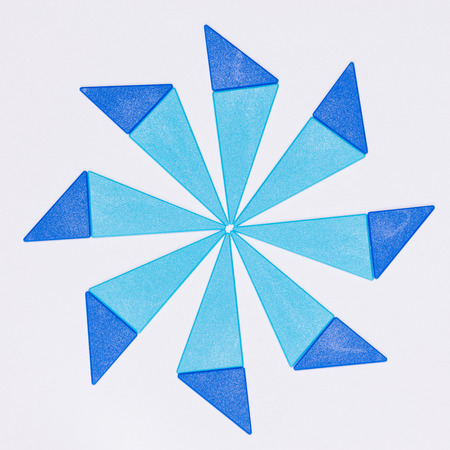 blue snowflake made â€‹â€‹of triangles on a white background