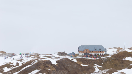 Zell am See - Kaprun - December 6, 2014: People at a ski resort in the Alps at an altitude of 3000 m on the glacier in the background of clouds Kitssteynhorn December 6, 2014, Zell am Cee - Kaprun, Austriaのeditorial素材