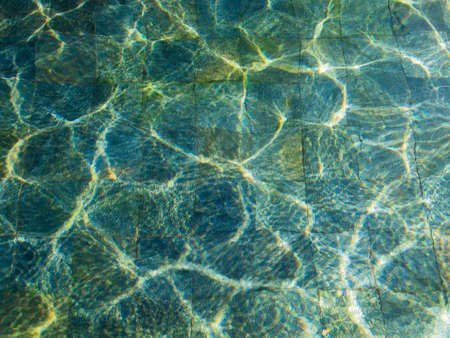 beautiful sun glare water and pearl tiles in the pool