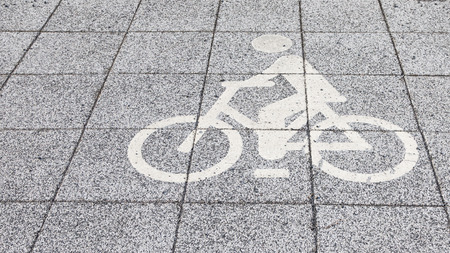 symbol of the bike path on the sidewalk gray tileの写真素材