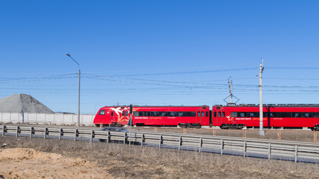 Sheremetyevo Airport -14 March 2015: Red Train aeroexpress Sheremetyevo quickly goes along the fence Airport March 14, 2015, Sheremetyevo Airport, Moscow Region, Russiaのeditorial素材