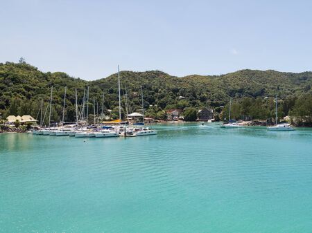 Praslin - November 10, 2014: Many beautiful white yacht in the port of the island of Praslin and green mountains away November 10, 2014, Praslin, Seychellesのeditorial素材