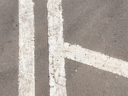 white markings on the old dirty gray asphaltの写真素材