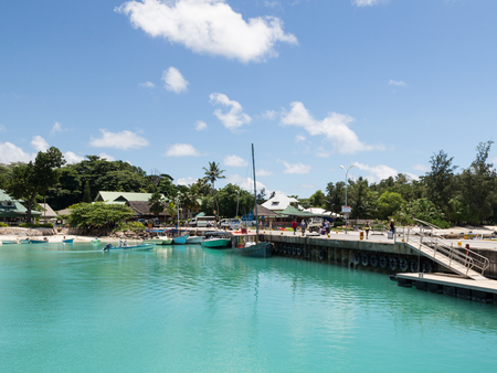 La Digue - November 10, 2014: The port on an exotic tropical island and people are waiting for the ferry November 10, 2014, La Digue, Seychellesのeditorial素材