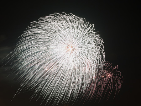 spectacular beautiful bright fireworks in a white bowl in a black night skyの写真素材